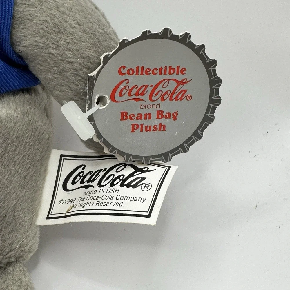 Coca-Cola collectible bean‎ bag plush seal from 1998, wearing a delivery outfit